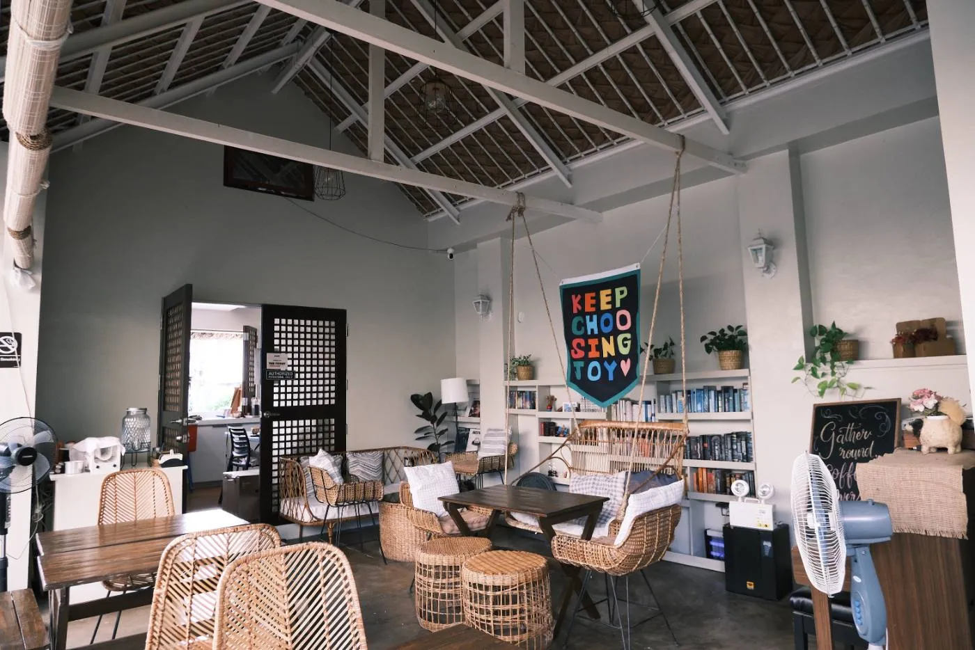 The airy coffee house interior with rattan chairs under the nipa roof
