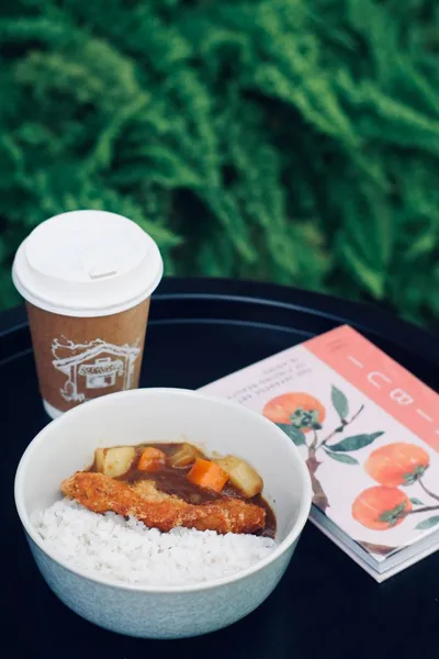 Chicken katsu curry bowl with a Kape Maria cup