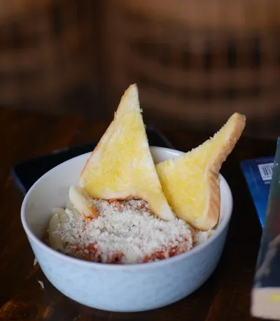 Tomato penne pasta topped with parmesan
