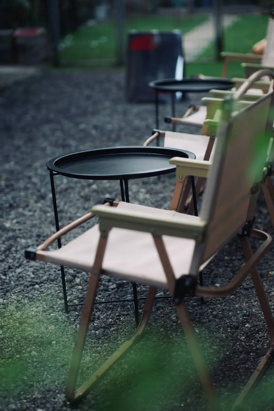 Outdoor camp chairs and side tables on the gravel garden